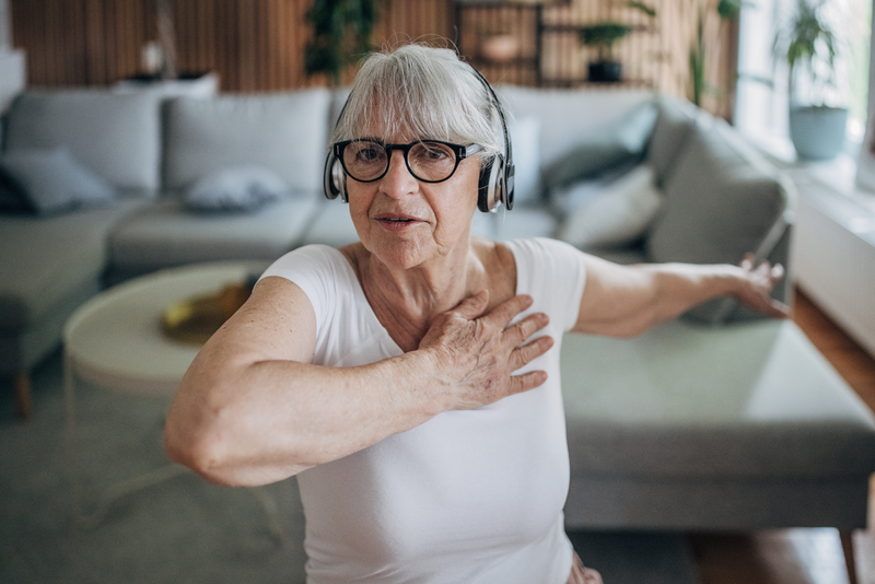 Senior woman listening to music at home while exercising - stock photo
Senior woman listening to music at home while exercising