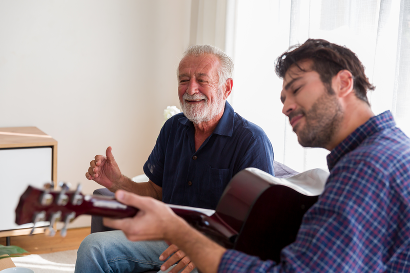 Happy Senior Father sing a song and Adult Son playing guitar on the sofa at home. Elderly father and son spending time together at home. - stock photo
Happy Senior Father sing a song and Adult Son playing guitar on the sofa at home. Elderly father and son spending time together at home.
