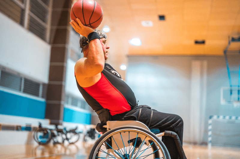 Male Wheelchair Basketball Player Passing The Ball - stock photo
Low angle view of male wheelchair basketball players passing the ball during practice.