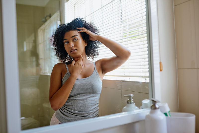 Shot of a beautiful young woman inspecting her skin in the bathroom mirror - stock photo
My skin seems to look better by the day