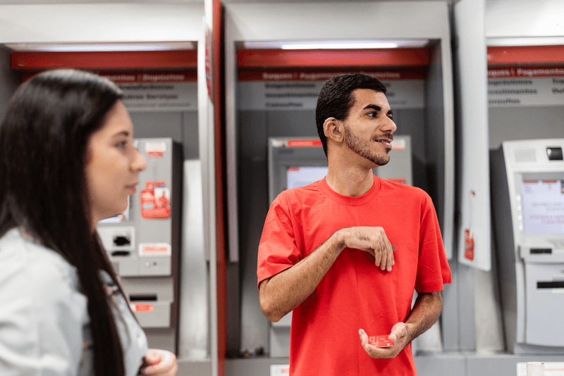 Young man in sign language at bank branch - stock photo
Deaf youth communicating about finance within the bank branch