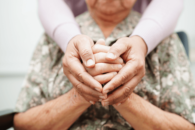 Caregiver holding hands Asian elderly woman patient, help and care in hospital.